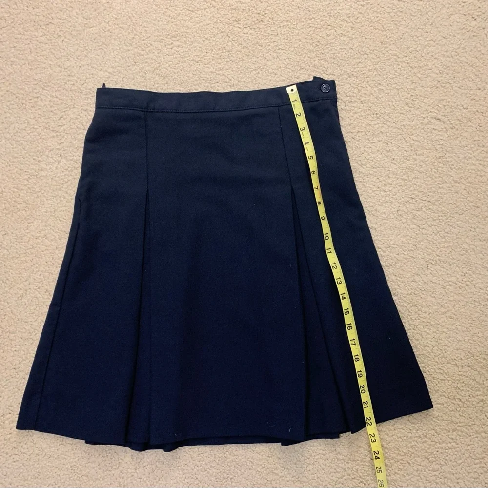 Navy blue pleated skirt with adjustable waist.